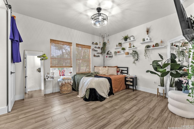 740 Sharp Spgs, Bulverde, TX 78163 - bedroom featuring light wood-style floors, baseboards, and a chandelier