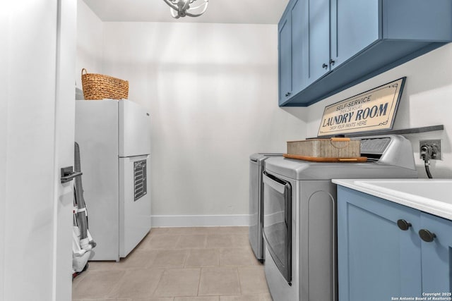 740 Sharp Spgs, Bulverde, TX 78163 - clothes washing area with cabinet space, washing machine and clothes dryer, baseboards, and light tile patterned floors