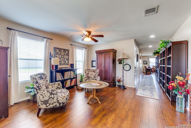 living area featuring wood finished floors, a ceiling fan, baseboards, and recessed lighting