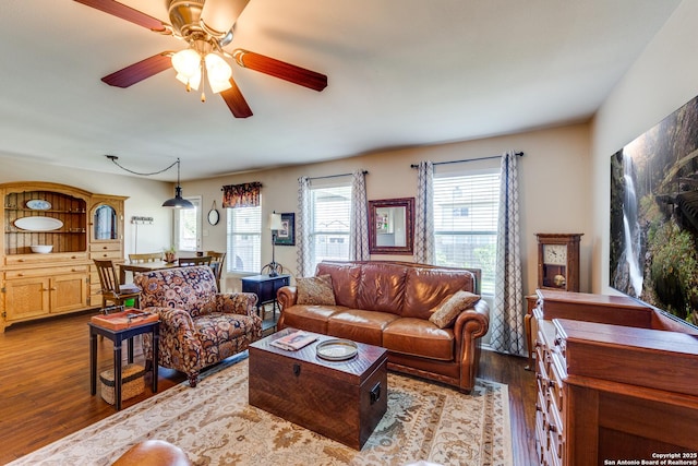 living room featuring wood finished floors and a ceiling fan
