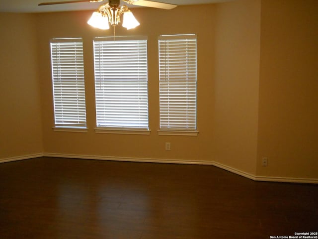 unfurnished room with ceiling fan, baseboards, and wood finished floors