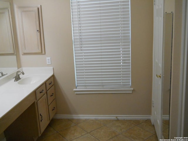 bathroom featuring baseboards, vanity, and tile patterned floors