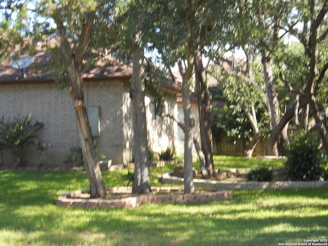 view of side of home with a lawn