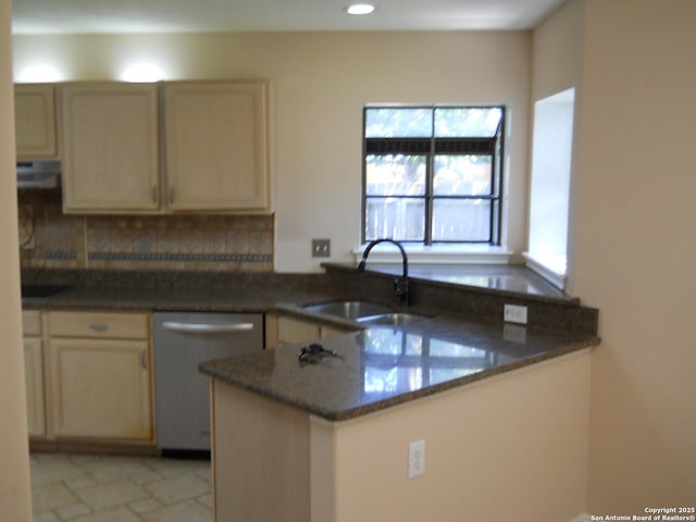 kitchen with dishwasher, a sink, a peninsula, tasteful backsplash, and under cabinet range hood