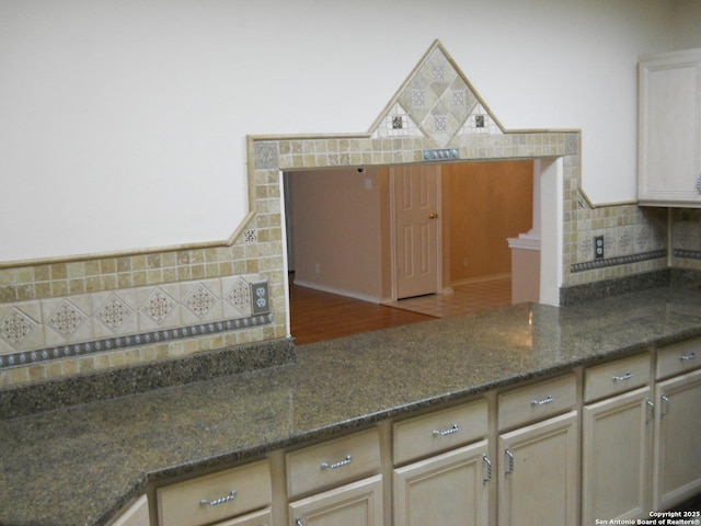 kitchen featuring tasteful backsplash and dark stone counters