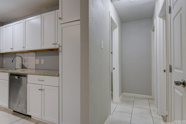 4342 Lehman Dr, Kirby, TX 78219 - kitchen featuring dishwasher, a sink, light tile patterned flooring, and white cabinets
