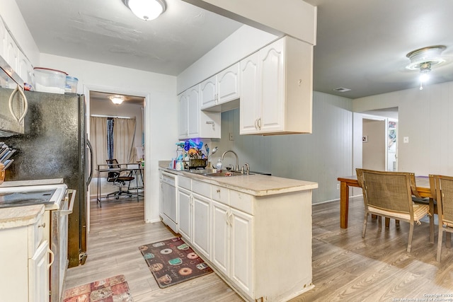 5118 Crusade Dr, San Antonio, TX 78218 - kitchen with a sink, white appliances, light wood-type flooring, light countertops, and white cabinetry