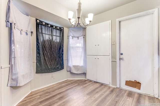 5118 Crusade Dr, San Antonio, TX 78218 - unfurnished dining area featuring a chandelier, wood finished floors, and baseboards
