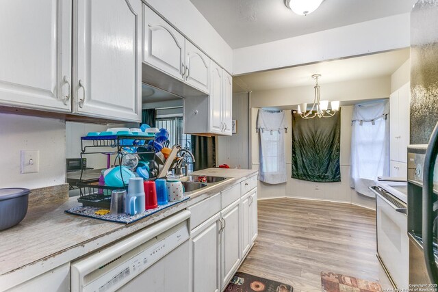5118 Crusade Dr, San Antonio, TX 78218 - kitchen featuring white appliances, a sink, white cabinets, a chandelier, and light wood finished floors