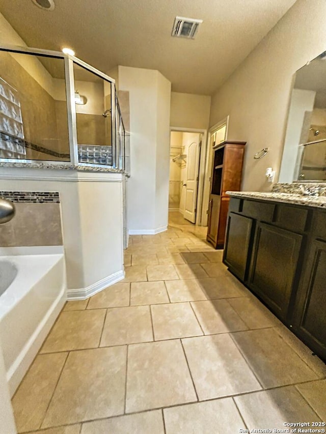 6635 Cibola Frst, San Antonio, TX 78233 - full bathroom with a shower stall, a garden tub, baseboards, tile patterned flooring, and a textured ceiling
