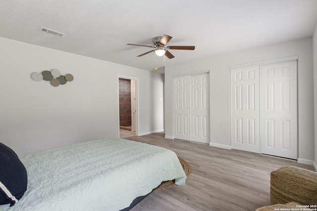 3115 Bluefield, San Antonio, TX 78230 - bedroom featuring multiple closets, wood finished floors, baseboards, and ceiling fan