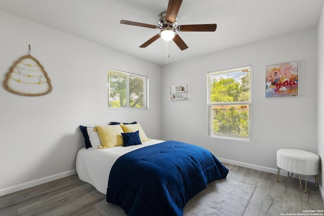3115 Bluefield, San Antonio, TX 78230 - bedroom with multiple windows, baseboards, wood finished floors, and a ceiling fan