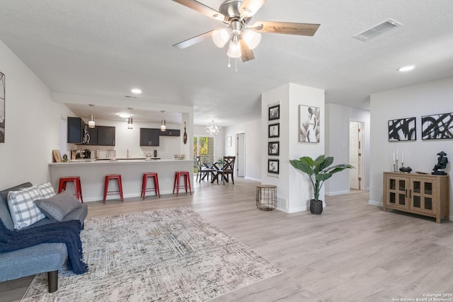 3115 Bluefield, San Antonio, TX 78230 - living area with light wood-type flooring, ceiling fan, a chandelier, baseboards, and recessed lighting