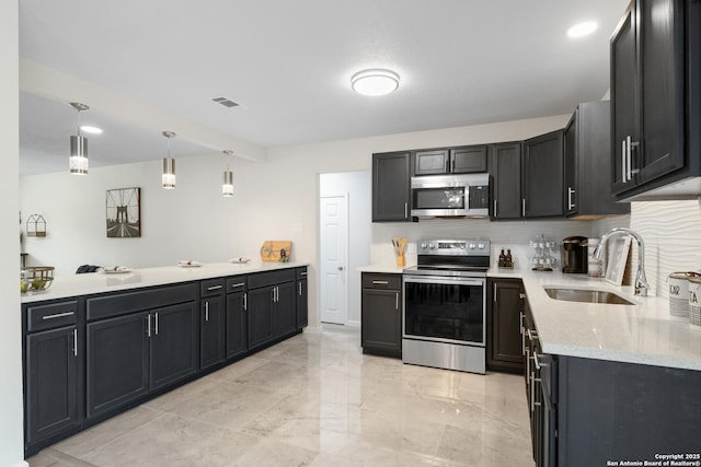 3115 Bluefield, San Antonio, TX 78230 - kitchen featuring appliances with stainless steel finishes, a sink, backsplash, light stone countertops, and dark cabinets
