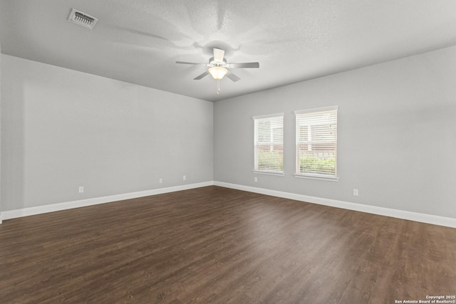 10307 Royal, San Antonio, TX 78245 - empty room with dark wood finished floors, ceiling fan, baseboards, and a textured ceiling