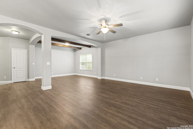 10307 Royal, San Antonio, TX 78245 - unfurnished living room featuring ceiling fan, dark wood-type flooring, baseboards, and arched walkways