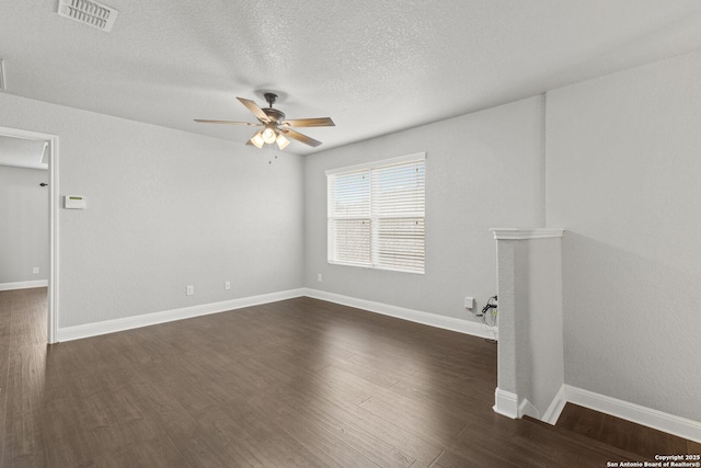 10307 Royal, San Antonio, TX 78245 - spare room featuring a ceiling fan, dark wood-style floors, a textured ceiling, and baseboards