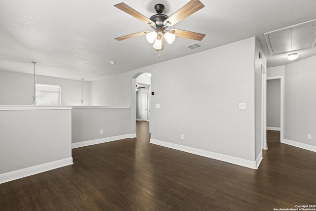 10307 Royal, San Antonio, TX 78245 - spare room with attic access, ceiling fan, wood finished floors, arched walkways, and a textured ceiling