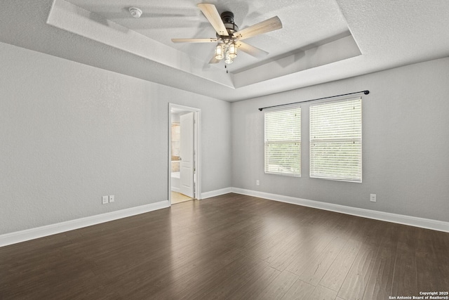 10307 Royal, San Antonio, TX 78245 - empty room with a raised ceiling, a ceiling fan, dark wood-type flooring, a smoke detector, and baseboards