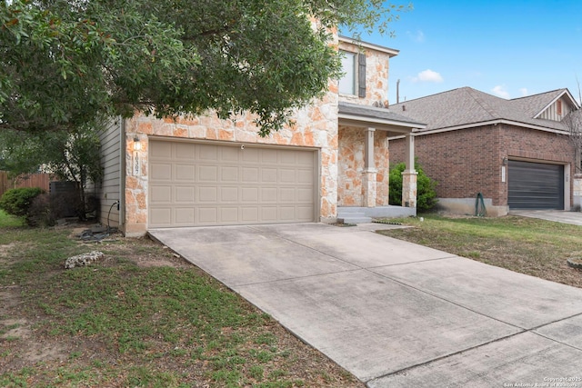10307 Royal, San Antonio, TX 78245 - view of property hidden behind natural elements with stone siding, driveway, and a garage