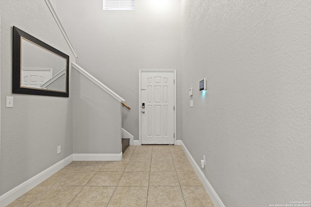 10307 Royal, San Antonio, TX 78245 - foyer entrance featuring stairs, light tile patterned floors, and baseboards