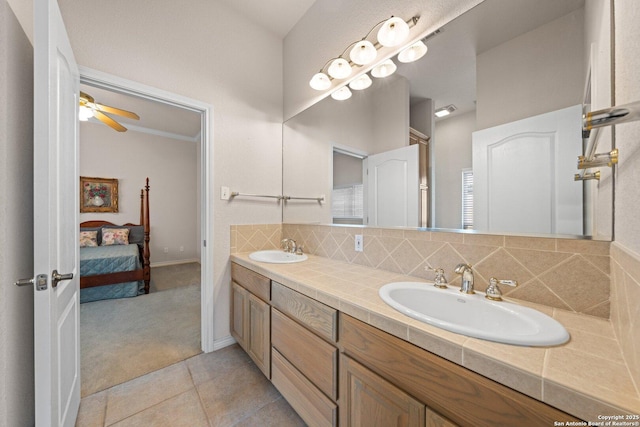 2001 Crown Rdg, Kerrville, TX 78028 - ensuite bathroom with double vanity, tasteful backsplash, tile patterned floors, and ceiling fan