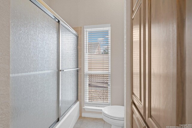2001 Crown Rdg, Kerrville, TX 78028 - bathroom with toilet, combined bath / shower with glass door, and tile patterned flooring