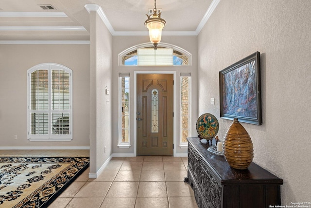 2001 Crown Rdg, Kerrville, TX 78028 - foyer with healthy amount of natural light, ornamental molding, a textured wall, light tile patterned floors, and baseboards
