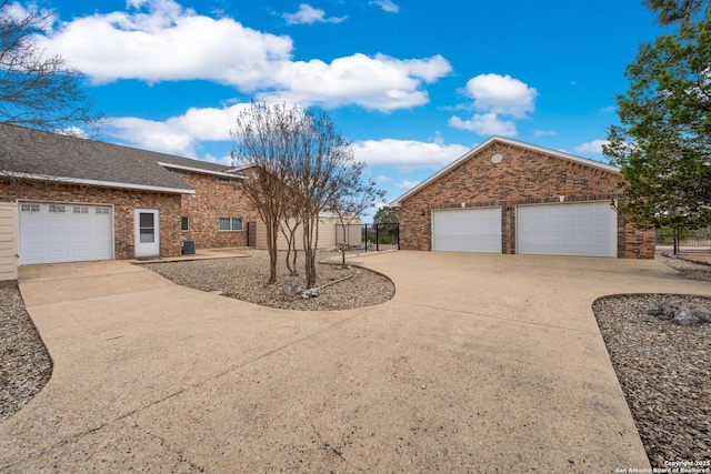 2001 Crown Rdg, Kerrville, TX 78028 - view of front facade featuring brick siding, fence, a garage, and central AC unit
