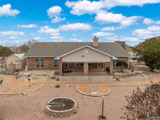2001 Crown Rdg, Kerrville, TX 78028 - back of house with fence, a chimney, a shingled roof, and brick siding