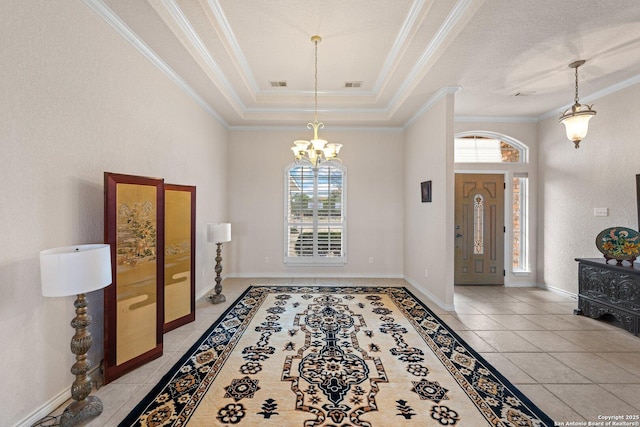 2001 Crown Rdg, Kerrville, TX 78028 - entryway with plenty of natural light, a chandelier, crown molding, light tile patterned floors, and a raised ceiling
