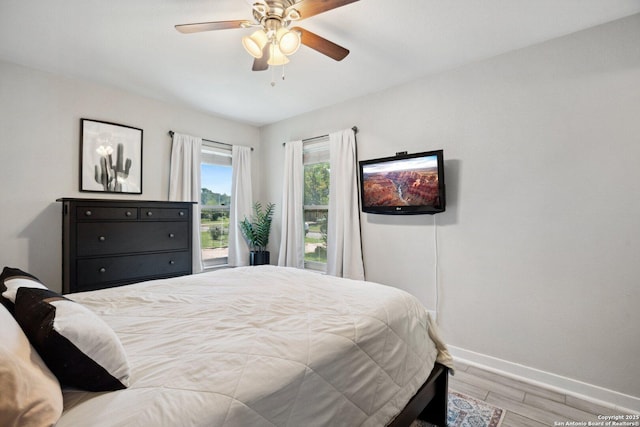3003 Shady Spgs, San Antonio, TX 78230 - bedroom featuring baseboards, wood finished floors, ceiling fan, and access to outside