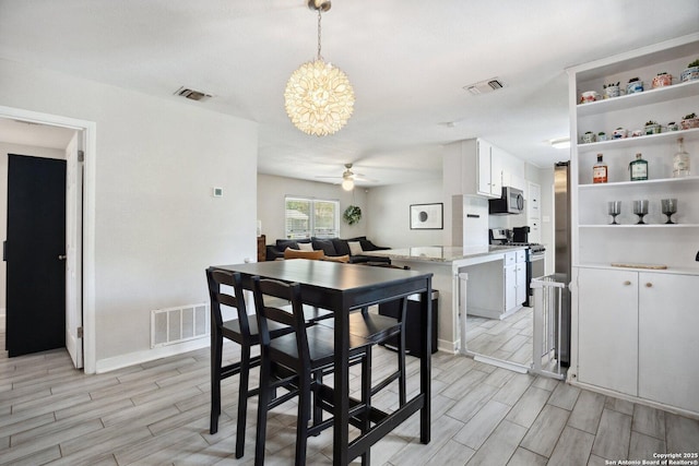 3003 Shady Spgs, San Antonio, TX 78230 - dining space featuring ceiling fan, wood finish floors, a chandelier, and baseboards