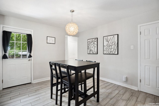3003 Shady Spgs, San Antonio, TX 78230 - dining area featuring a chandelier, wood tiled floors, and baseboards
