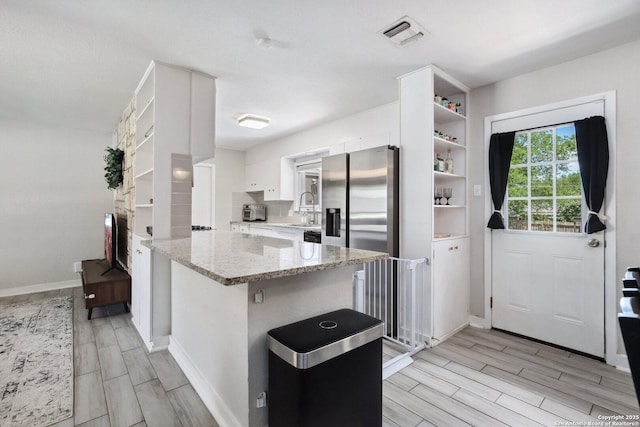 3003 Shady Spgs, San Antonio, TX 78230 - kitchen featuring open shelves, wood tiled floors, white cabinets, and a peninsula