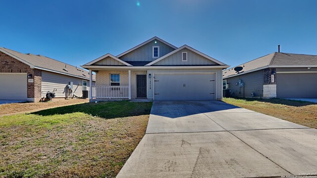 13778 Bradford Park, San Antonio, TX 78253 - view of front of property featuring board and batten siding, a porch, a front lawn, concrete driveway, and a garage