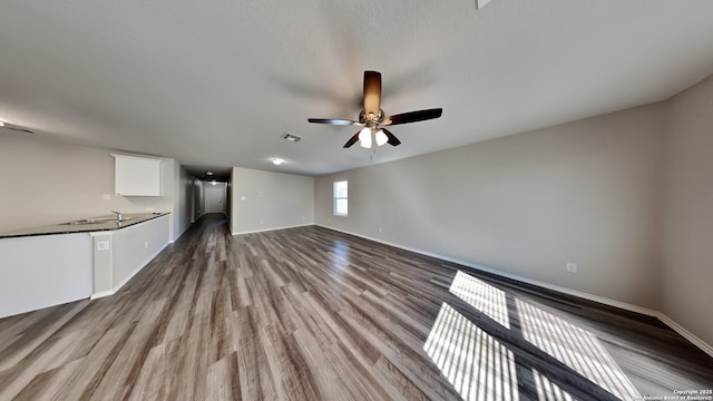13778 Bradford Park, San Antonio, TX 78253 - unfurnished living room with ceiling fan, wood finished floors, and baseboards