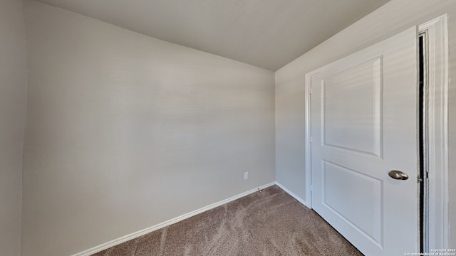 13778 Bradford Park, San Antonio, TX 78253 - unfurnished room with vaulted ceiling, dark colored carpet, and baseboards