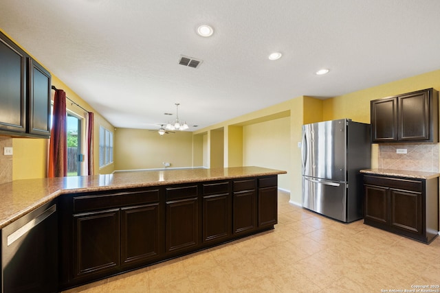7923 Martinelli, San Antonio, TX 78253 - kitchen with appliances with stainless steel finishes, a chandelier, backsplash, recessed lighting, and decorative light fixtures