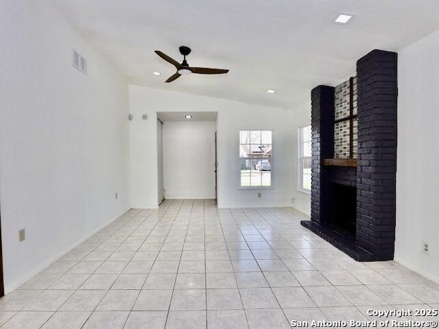 5530 Rangeland, San Antonio, TX 78247 - unfurnished living room with a ceiling fan, light tile patterned flooring, a brick fireplace, and vaulted ceiling