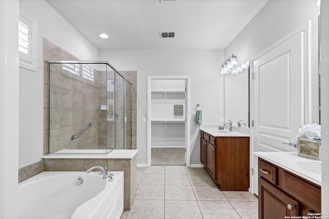 4602 Fort Boggy, San Antonio, TX 78253 - full bathroom featuring a stall shower, vanity, a garden tub, a walk in closet, and tile patterned floors