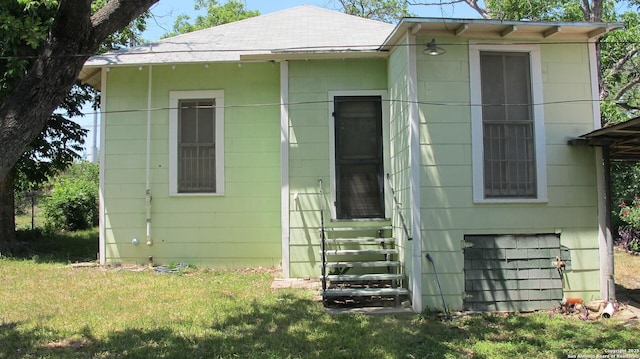 2222 Osburn, San Antonio, TX 78208 - view of front facade with a front yard, a shingled roof, and entry steps