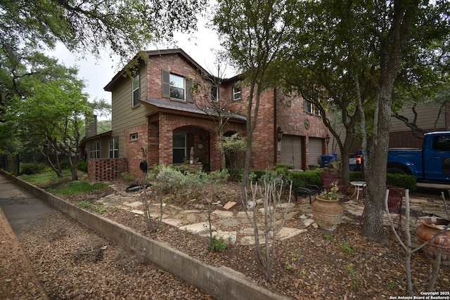 traditional-style home with brick siding and an attached garage
