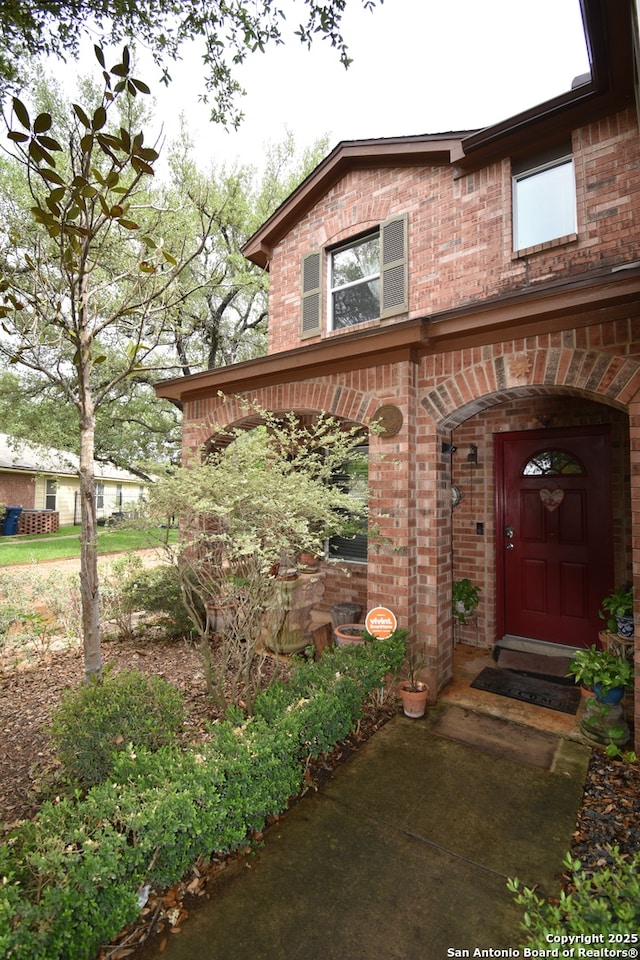 property entrance with brick siding