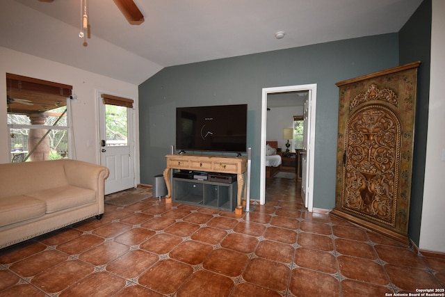 living area featuring ceiling fan and vaulted ceiling