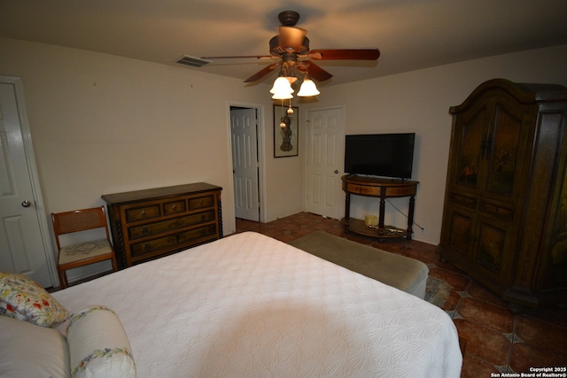tiled bedroom with a ceiling fan