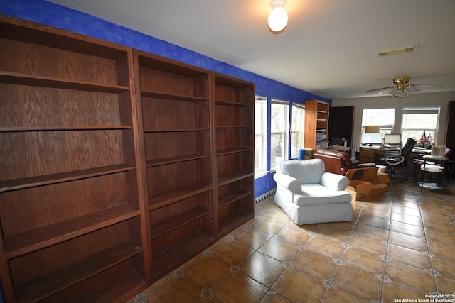 tiled living room featuring an office area, ceiling fan, and healthy amount of natural light
