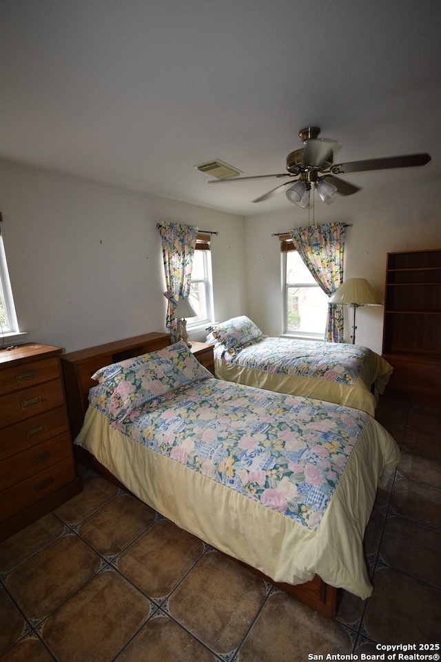 bedroom with tile patterned floors and ceiling fan