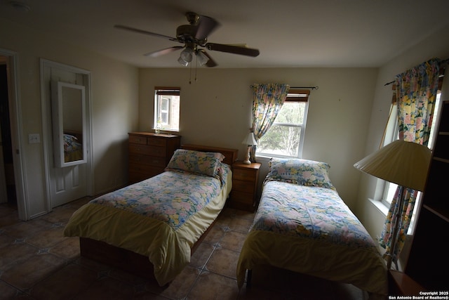 bedroom featuring tile patterned flooring and a ceiling fan