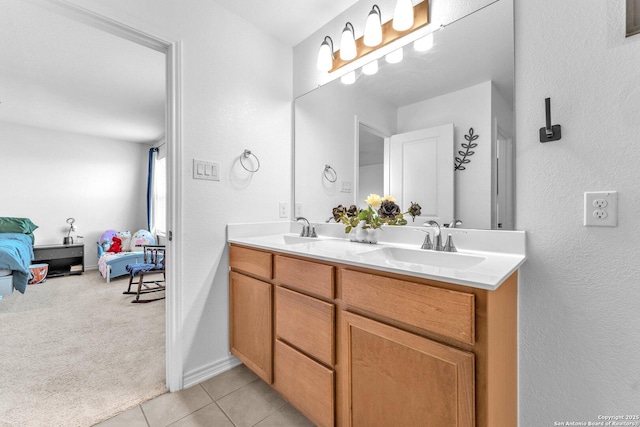 15836 Selene, San Antonio, TX 78245 - ensuite bathroom with double vanity, tile patterned flooring, baseboards, and a textured wall